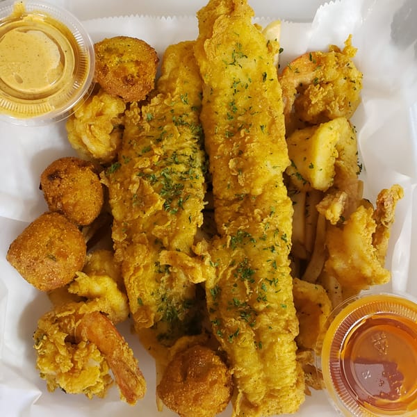 A Taste of New Orleans' fried fish, shrimp, hush puppies, and fries with dipping sauces.