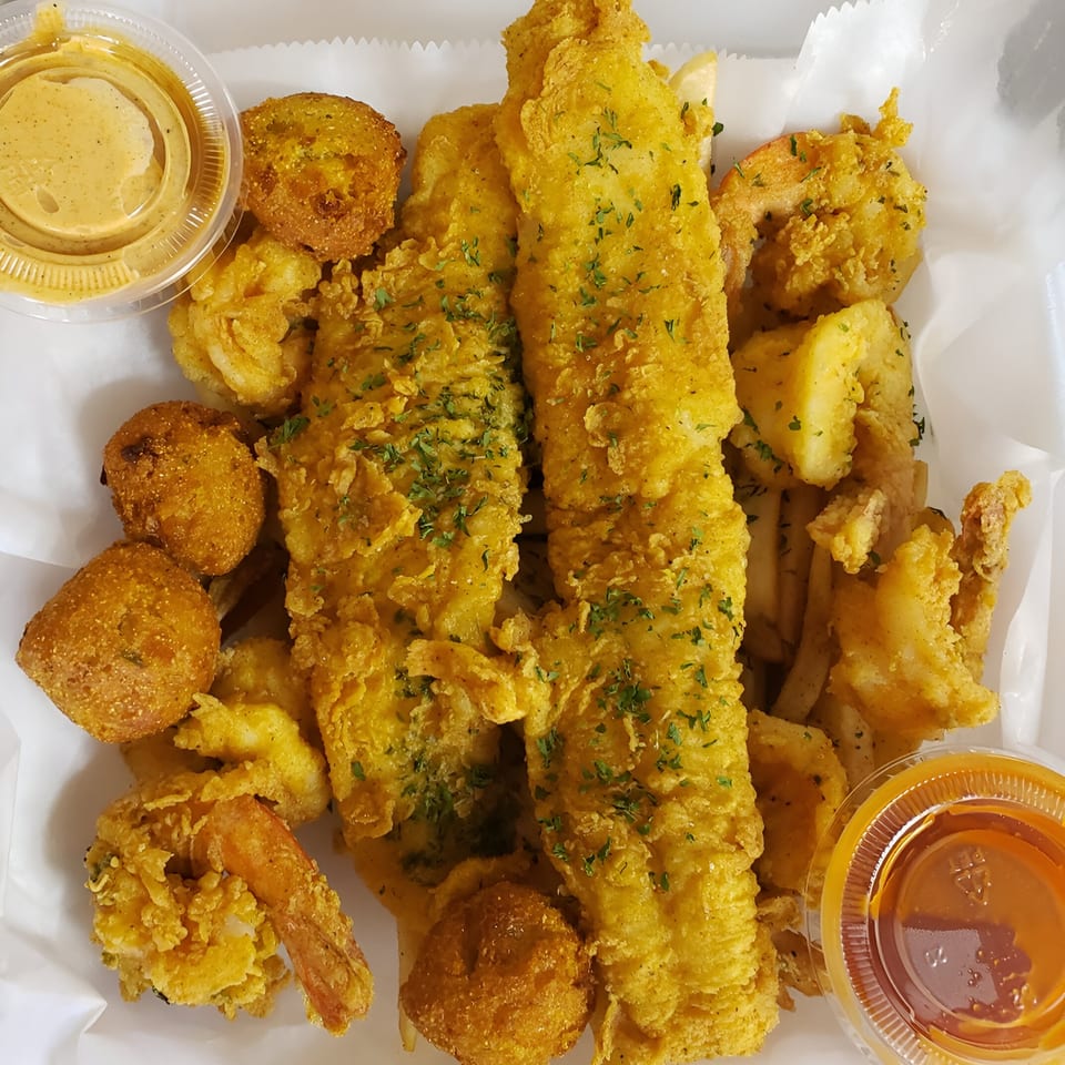 A Taste of New Orleans' fried fish, shrimp, hush puppies, and fries with dipping sauces.