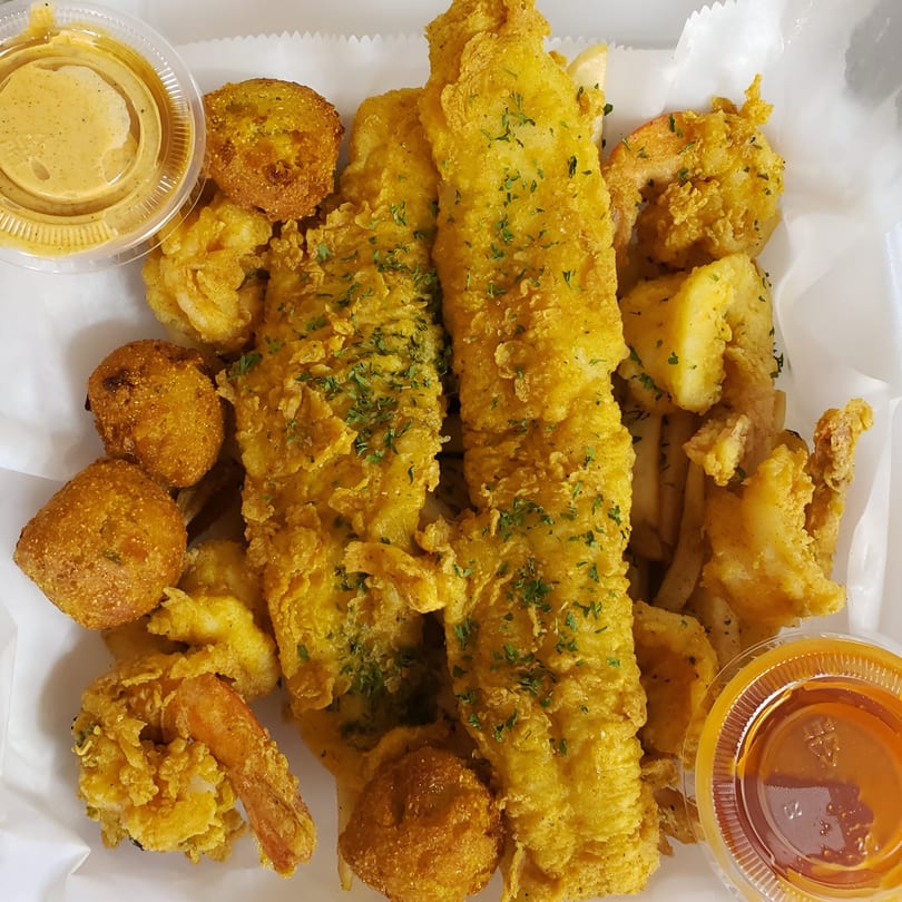 A Taste of New Orleans' fried fish, shrimp, hush puppies, and fries with dipping sauces.