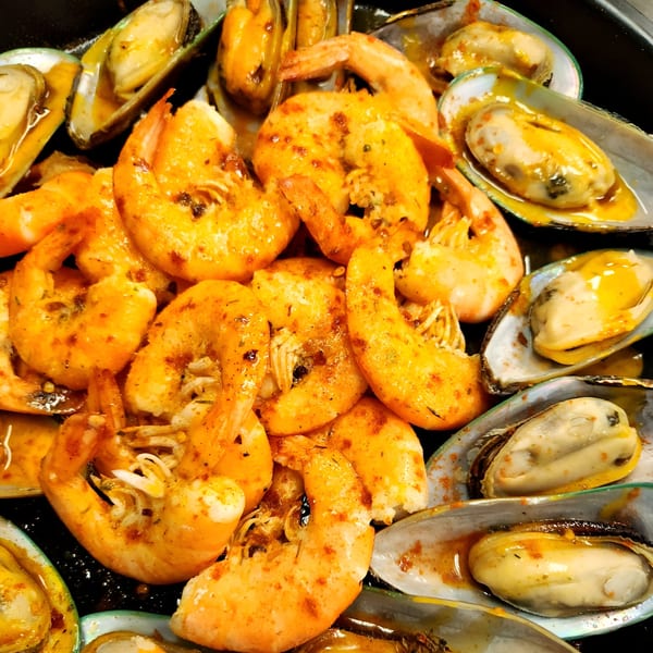 Cajun-spiced shrimp and mussels in a rich, flavorful sauce, ready to be enjoyed.