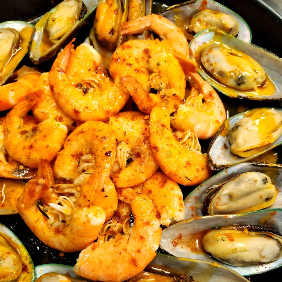Cajun-spiced shrimp and mussels in a rich, flavorful sauce, ready to be enjoyed.