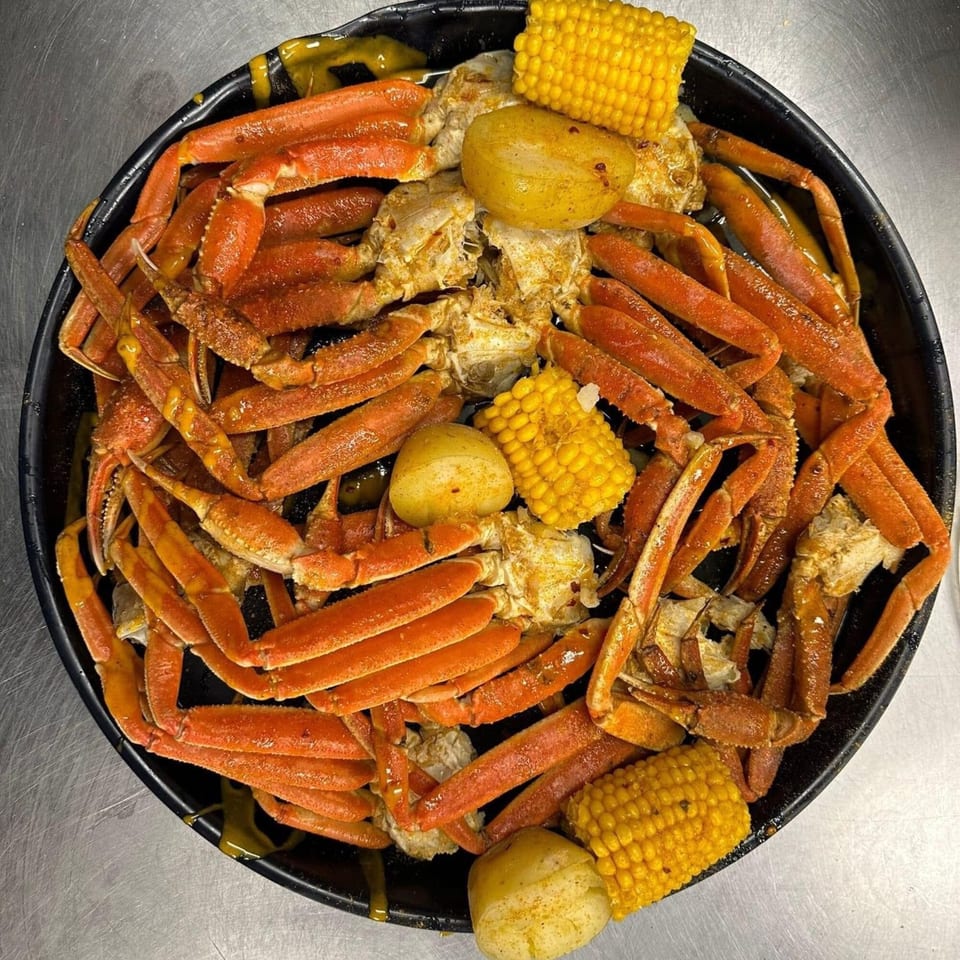 A Taste of New Orleans' Cajun crab boil with snow crab legs, corn on the cob, and potatoes.